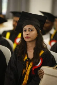 Students at The Apollo University attentively participate in their convocation ceremony.