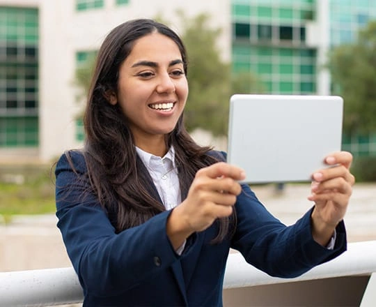 Student using a tablet on campus, representing hands-on learning in M.Tech Electronic & Embedded Systems program
