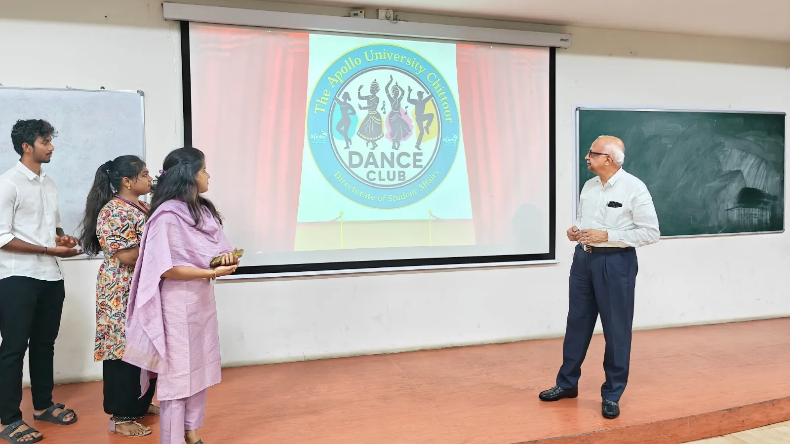 Students and Dr. Vinod Bhat unveil The Apollo University Dance Club logo during the launch event.