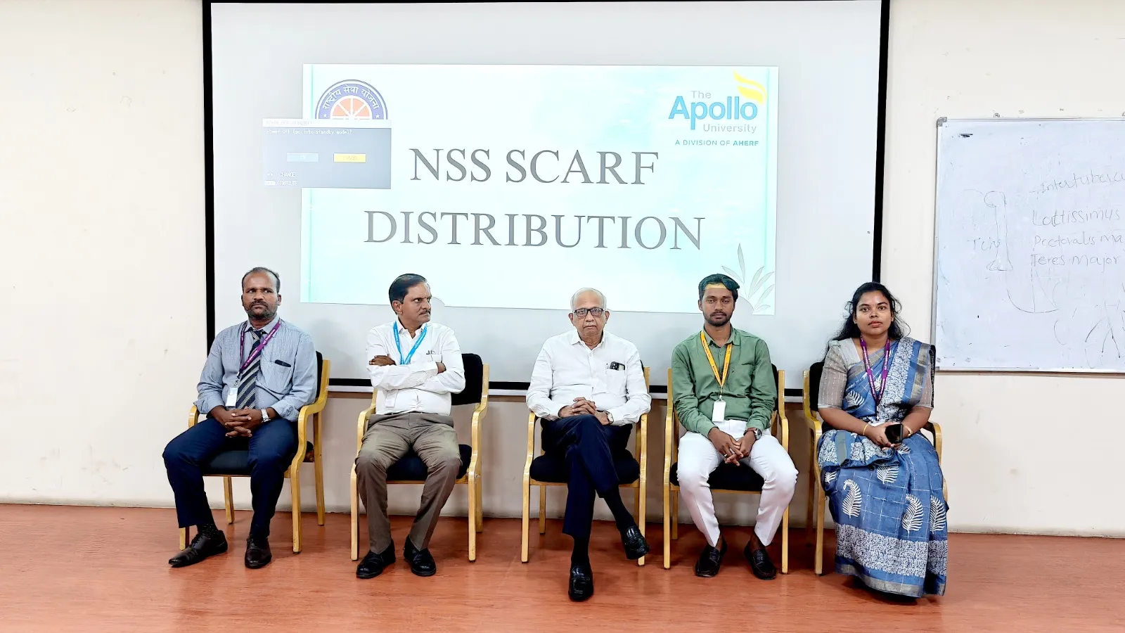 Dignitaries seated on stage at the NSS Scarf Distribution Ceremony at The Apollo University.