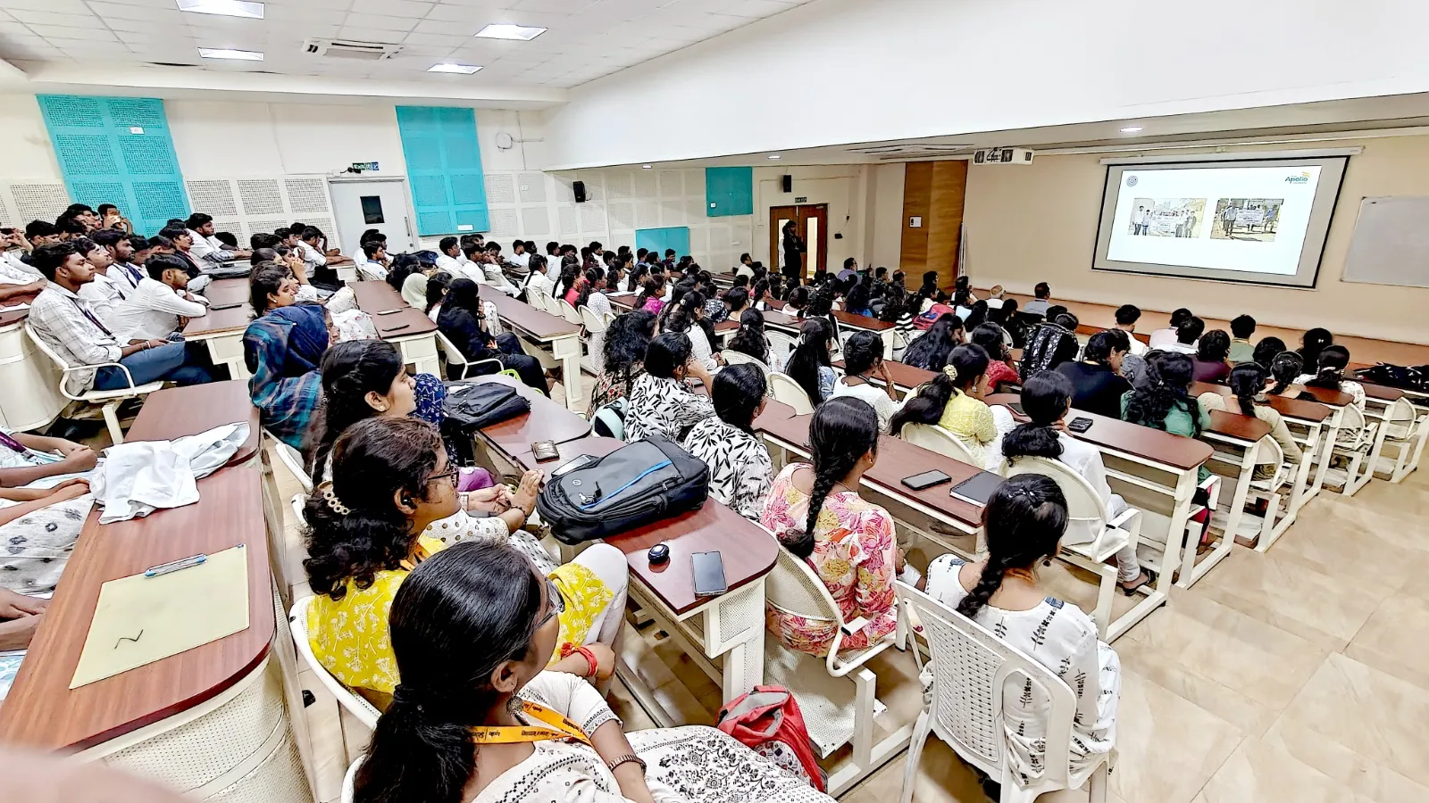 A large gathering of students is attending the NSS Scarf Distribution Ceremony at The Apollo University.