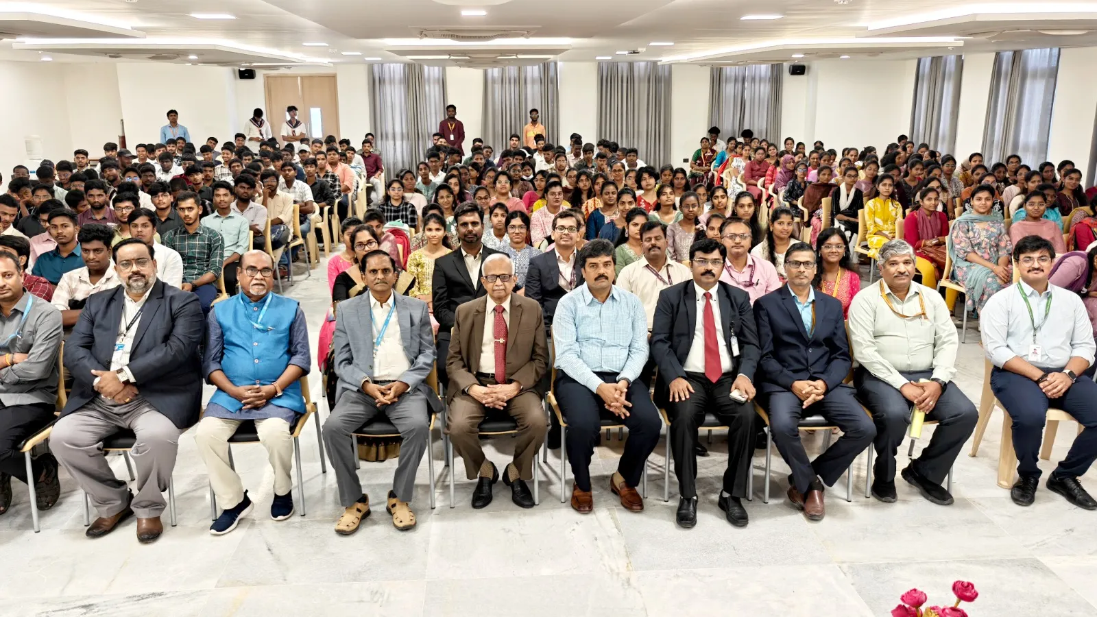 Dignitaries and faculty members seated with students during The Apollo University Induction Programme