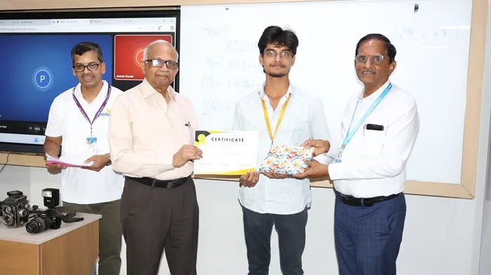 A student receiving a certificate from the Vice Chancellor on World Photography Day