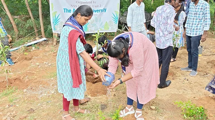 Student digging and planting trees as part of a green initiative Swachha Andhra Plantation Drive 2025