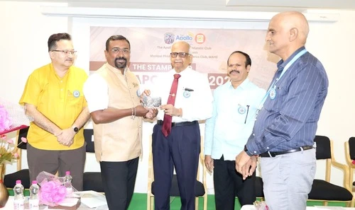 Vice Chancellor honoring Dr. Nishant Bhat at The Apollo University event.