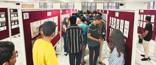 Visitors showing interest in exhibits at ApolloPEX-2025 event.