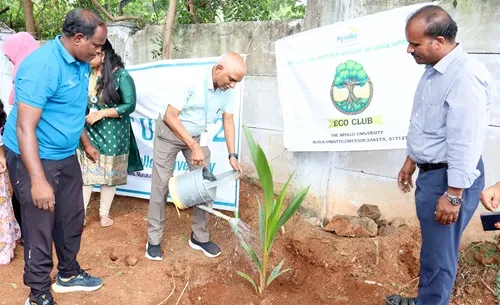 Prof. M. Potharaju participating in tree plantation activity on campus