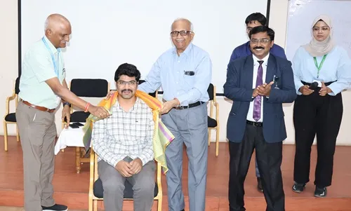 Shri Pradeep Kumar being honored by Dr. H. Vinod Bhat during Viksit Bharat event.