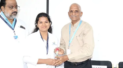Prof. M. Potharaju honoring the guest with a floral during World Pharmacists Day celebrations