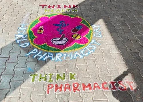 Rangoli created by students with pharmacy symbols for World Pharmacists Day