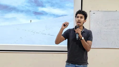Young presenter explaining wildlife topics with visual slides in classroom